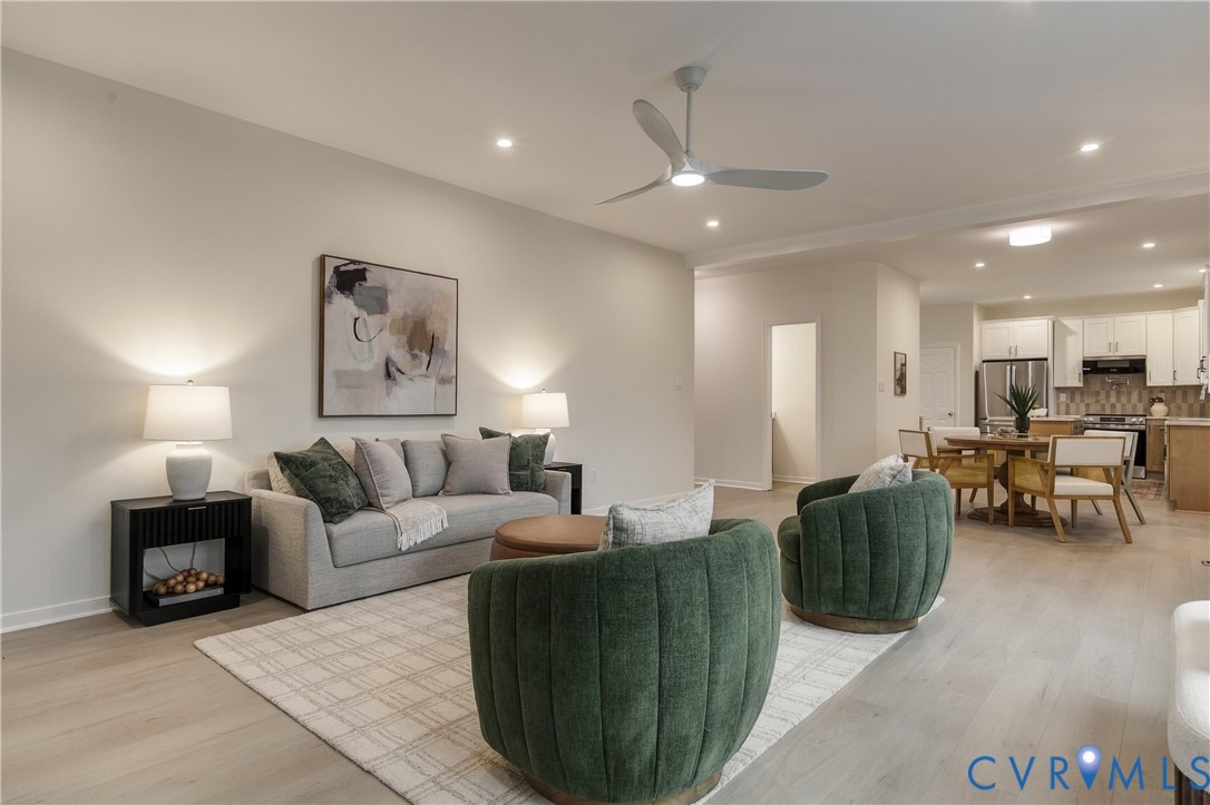 Open-concept interior featuring wood-finish flooring, recessed lighting, and a modern ceiling fan