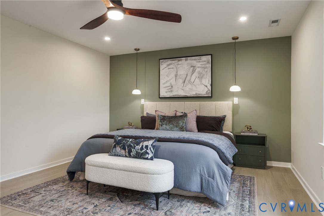 Bedroom featuring wood-finish flooring, recessed lighting, a ceiling fan, and dual pendant light fixtures