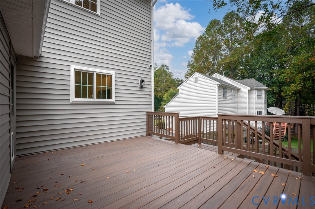 Elevated deck featuring composite wood-finish decking and perimeter railing