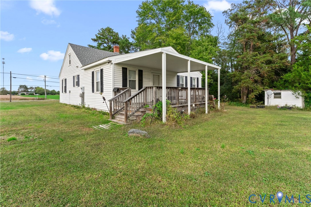 Rear of home with covered deck.