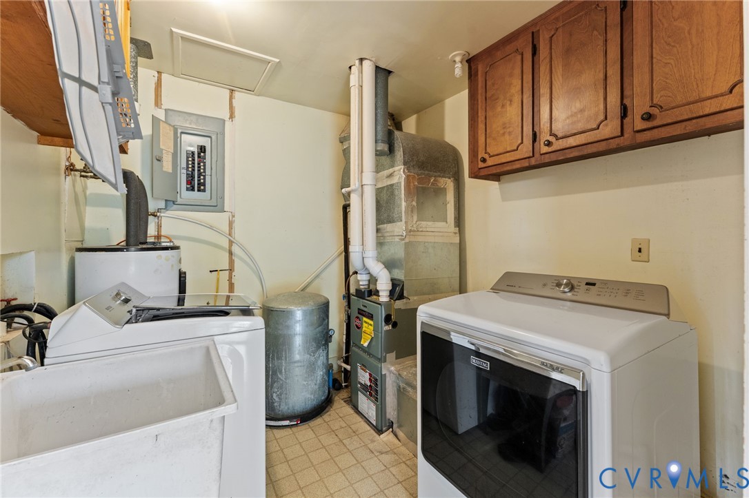 Utility/Laundry Room with cabinets for laundry supplies & utility sink.