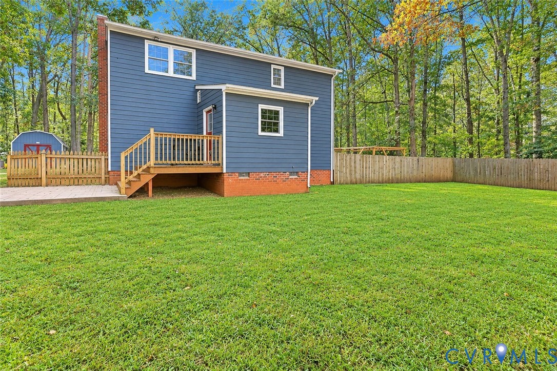 Rear fenced in backyard. *Photo digitally enhanced; grass and select personal items removed*