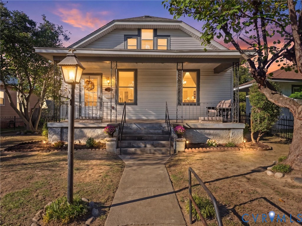 Bungalow residence featuring horizontal siding, a covered front porch, decorative gable windows