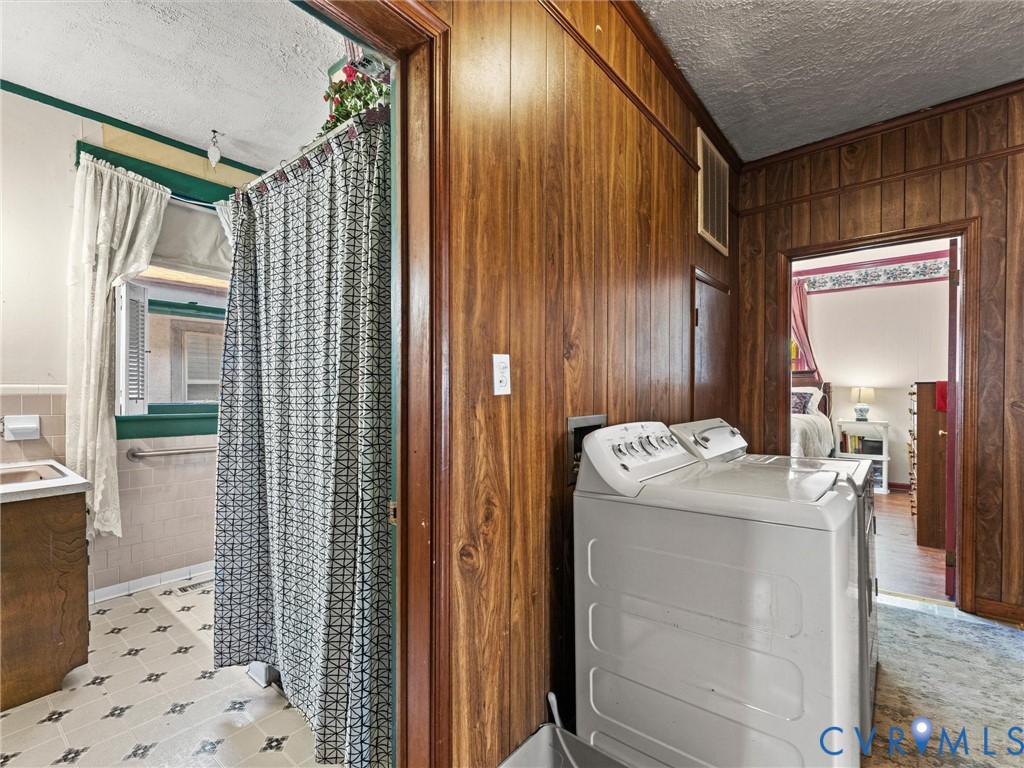 Wood-panelled wall treatments, vinyl flooring, and built-in vanity cabinet