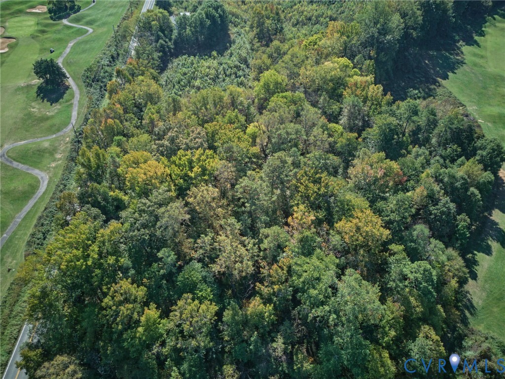Expansive lot featuring dense mature forest canopy and borders directly on a golf course