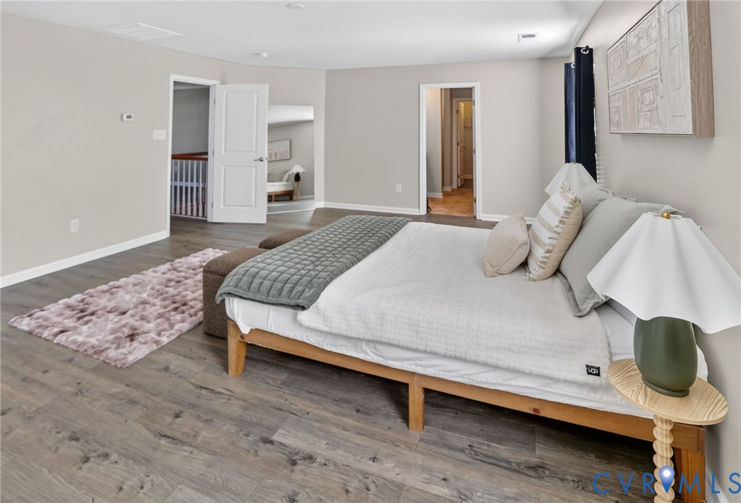 Neutral-toned interior featuring wood-finish flooring, crisp white interior doors, and clean lines