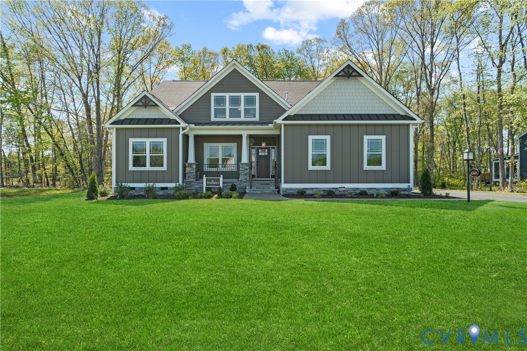 Craftsman-style exterior featuring vertical and shingle siding, a stone-veneer foundation, a covered front porch with round columns, and a multi-gabled roofline