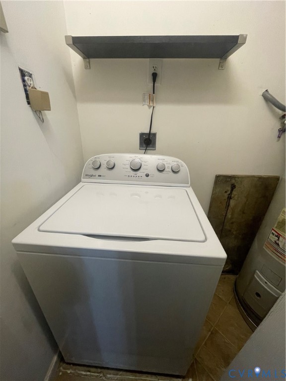 Utility area featuring a top-load washing machine and a wall-mounted shelf