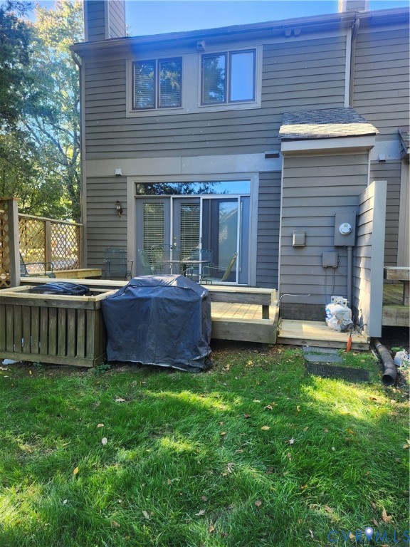 Exterior featuring horizontal siding, multi-level wood decking, integrated wood planter boxes, sliding glass doors, and lattice privacy screening