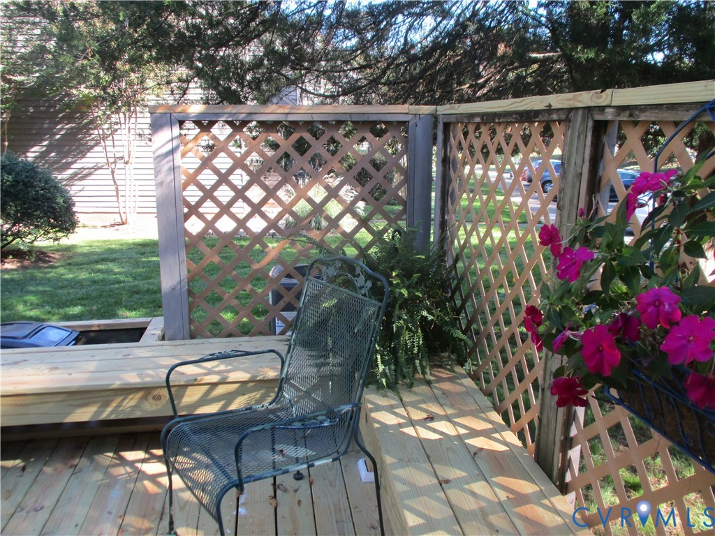 Outdoor deck featuring pressure-treated lumber decking, built-in bench seating, and wood lattice privacy screening