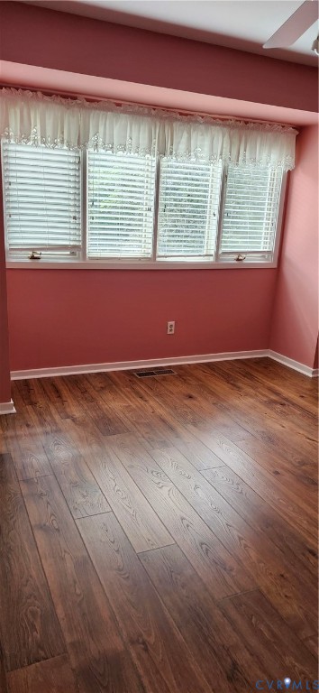 Wood-finish flooring, multi-panel window configuration with adjustable blinds, and integrated ceiling trim