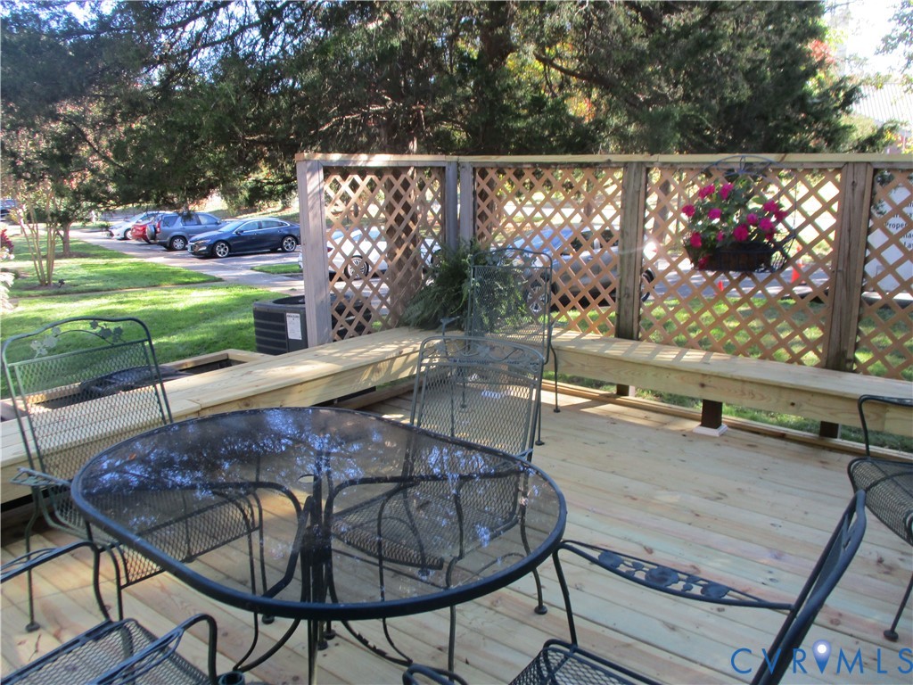 Wood decking featuring built-in bench seating and decorative wood lattice privacy screening