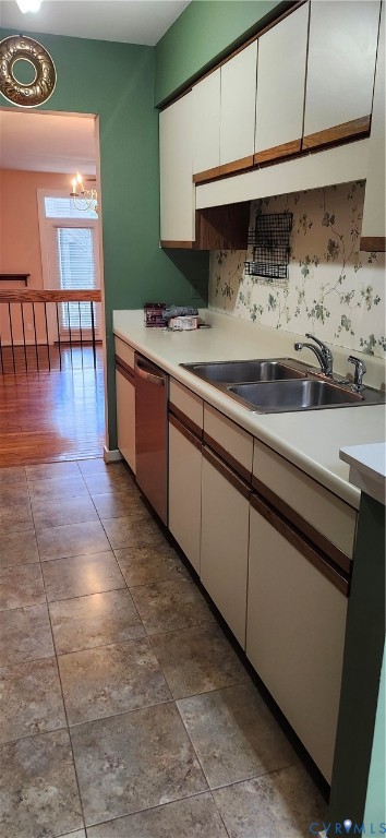 Kitchen featuring cabinetry with integrated wood pulls,-double-basin stainless steel sink, and ceramic tile flooring