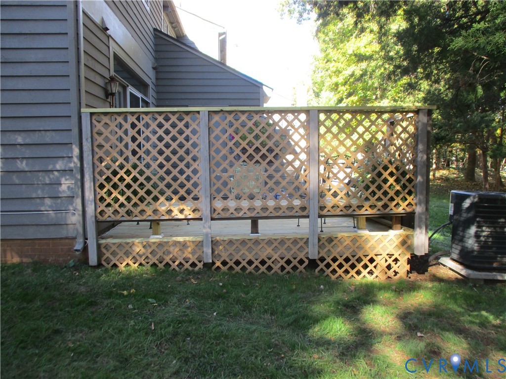Back deck featuring wood lattice screen panels and latticed skirting