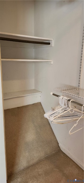Closet featuring built-in shelving and dual-tier hanging rods