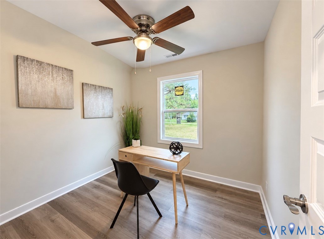 Wood-finish flooring, ceiling fan with integrated light fixture, and single-pane window