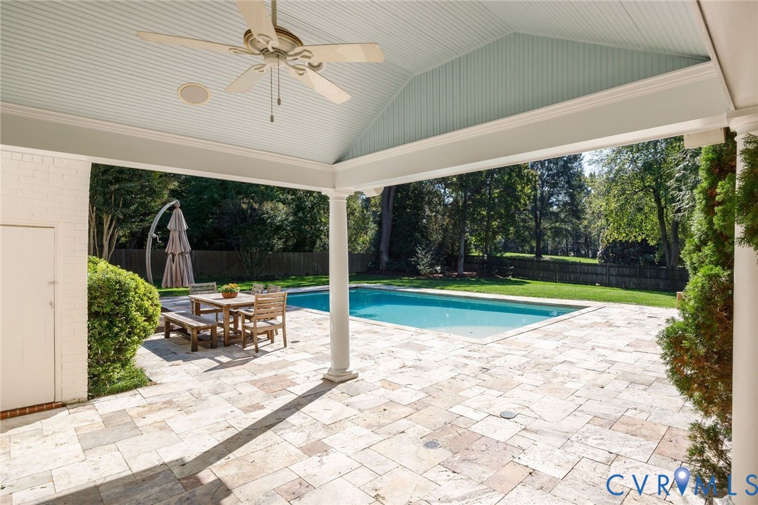 Step out to the covered travertine patio. The pool shed discreetly holds chemicals and equipment. The new owner will love the brand new pool cover and heater.