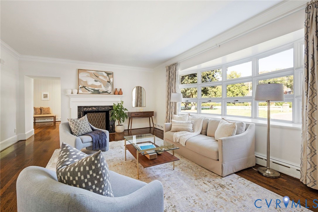 The grand living room enjoys a large bay window and fireplace.