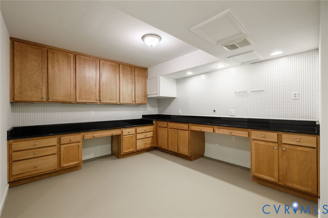 Workshop/craft room with granite counters.