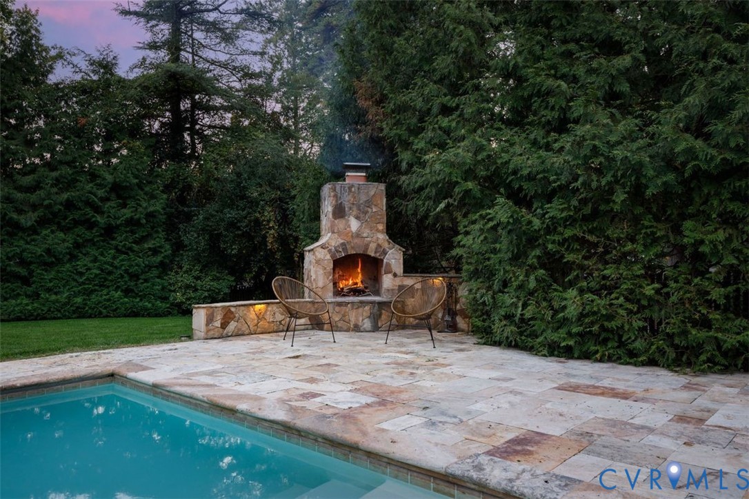 Stone fireplace keeps the outdoor space inviting every season.