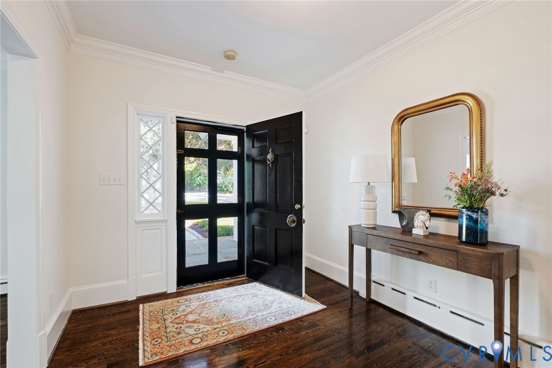 Welcoming foyer with hardwoods and elegant moldings.