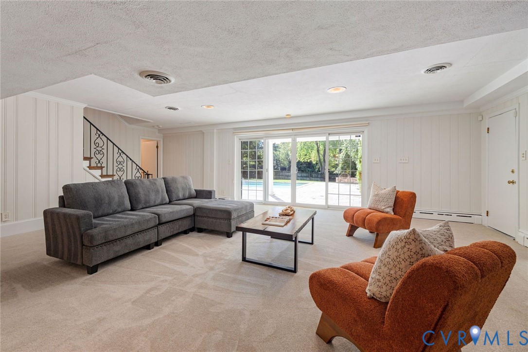 The basement rec room opens directly to the covered patio and pool.