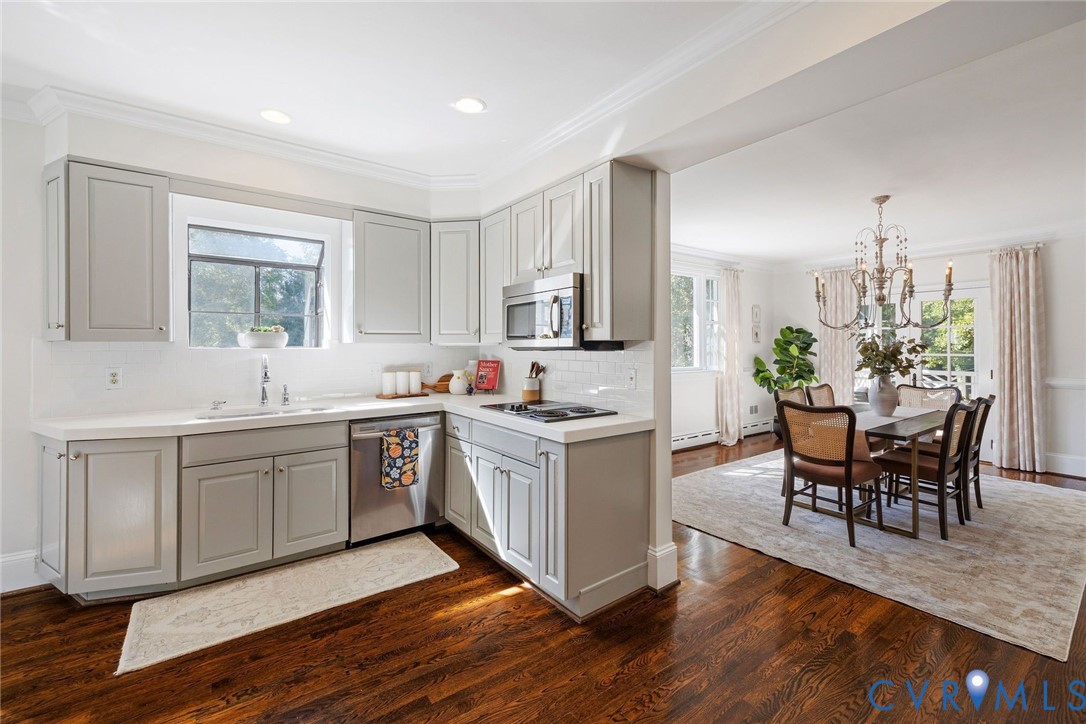 The open kitchen features quartz counters, stainless appliances and custom cabinets.
