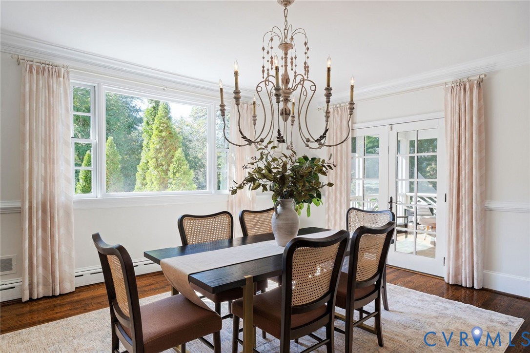 Chic chandelier and window dressings frame the original moldings, hardwoods and abundance of natural light.