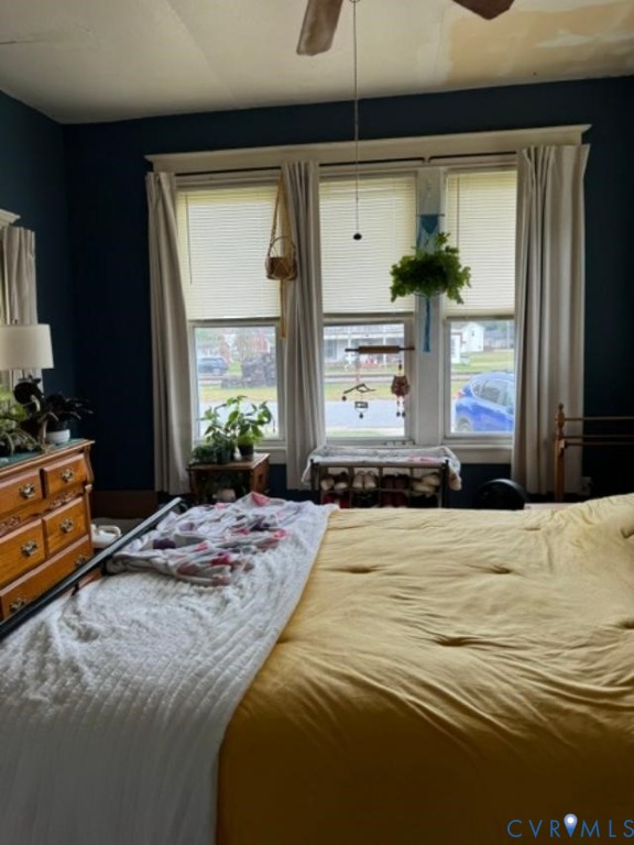 Triple window assembly with white casings, ceiling-mounted fan, and dark-toned wall finish Triple window assembly with white casings, ceiling-mounted fan, and dark-toned wall finish