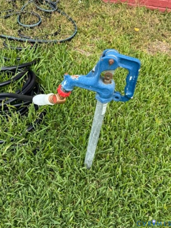 Outdoor yard hydrant featuring a heavy-duty blue cast iron handle and galvanized steel standpipe
