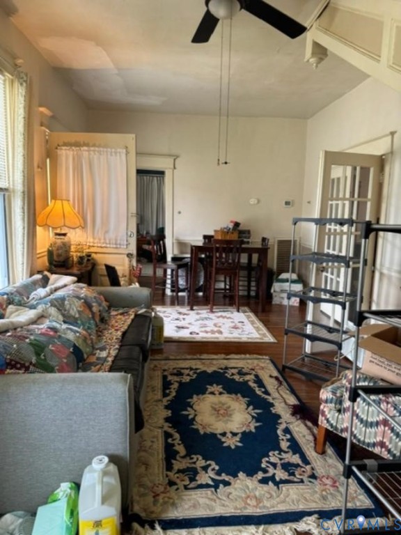 Interior space featuring wood-finish flooring, a ceiling-mounted fan, and a multi-pane glass-panel door Interior space featuring wood-finish flooring, a ceiling-mounted fan, and a multi-pane glass-panel door