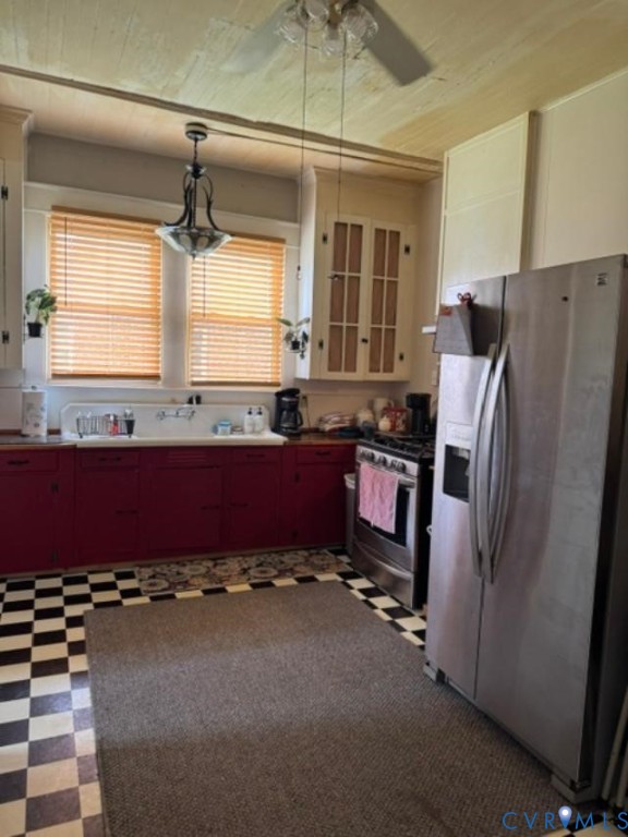 Kitchen featuring checkerboard tile flooring, built-in cabinetry , stainless steel refrigerator and range, and an integrated basin sink Kitchen featuring checkerboard tile flooring, built-in cabinetry , stainless steel refrigerator and range, and an integrated basin sink