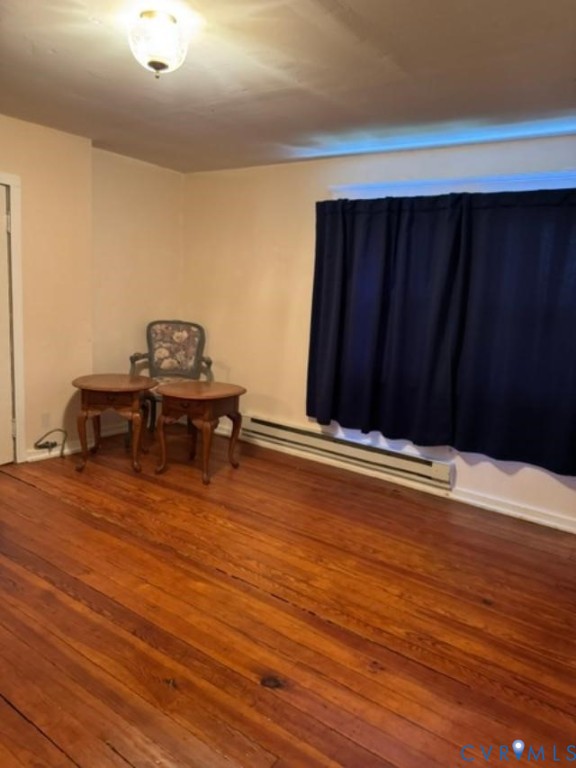 Wood-finish flooring, interior door, ceiling-mounted light fixture, and horizontal heating unit