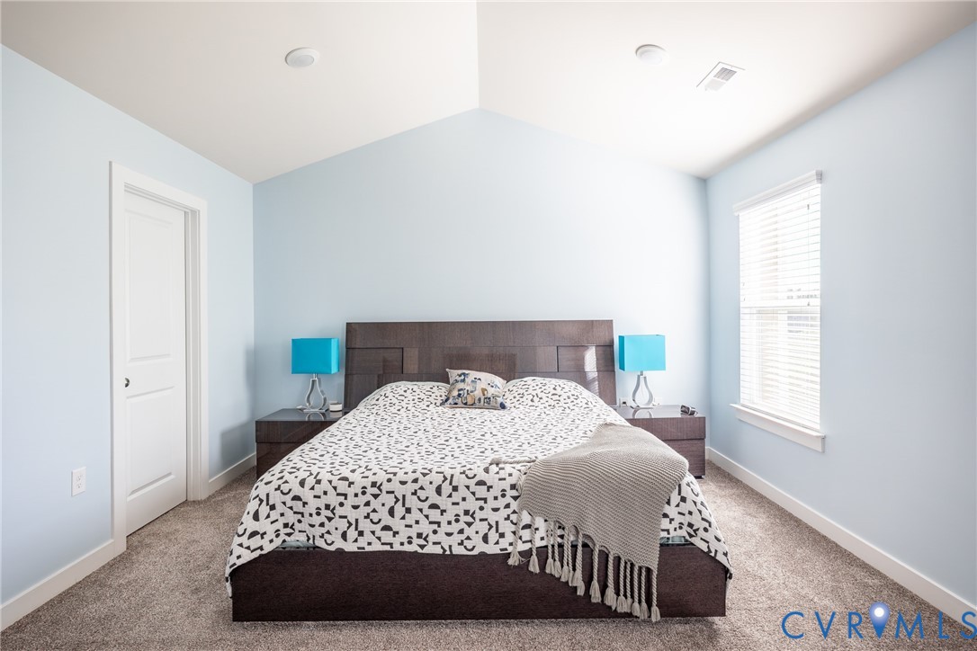 Neutral interior featuring wall-to-wall carpeting, double-panel closet doors, and a ceiling-mounted flush light fixture