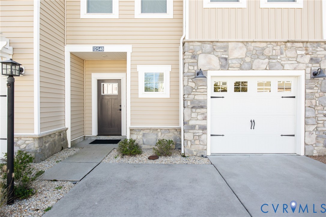 entry door, driveway, and garagef entry door, driveway, and garagef