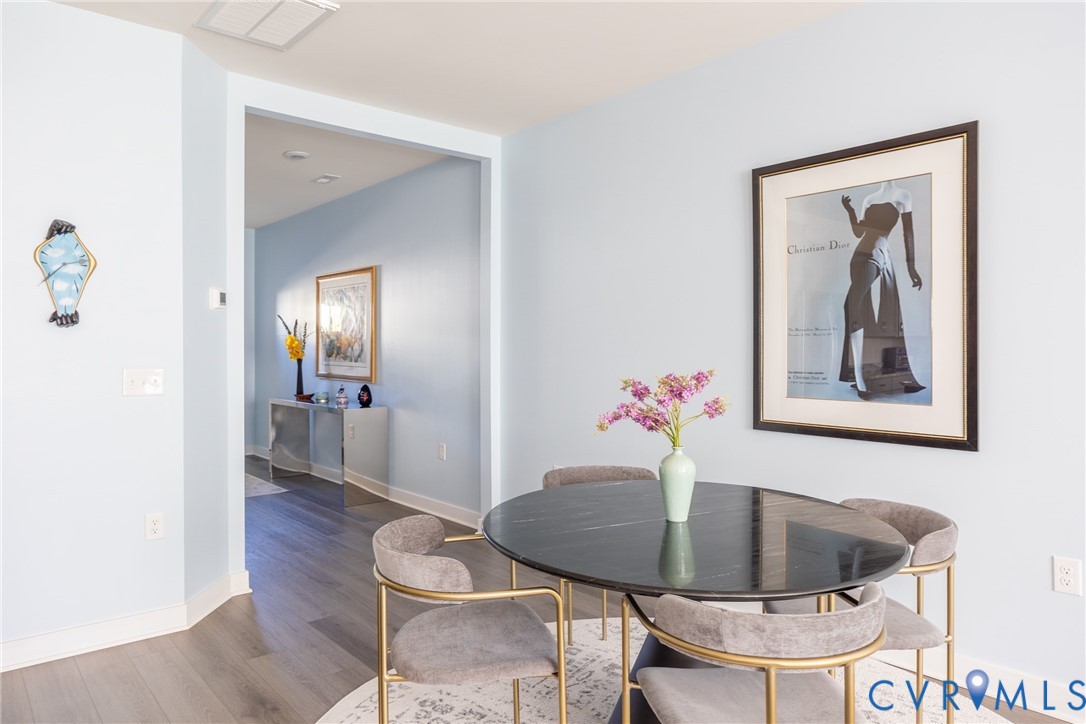 Light-toned interior wall paint, wood-finish flooring, and recessed ceiling lighting
