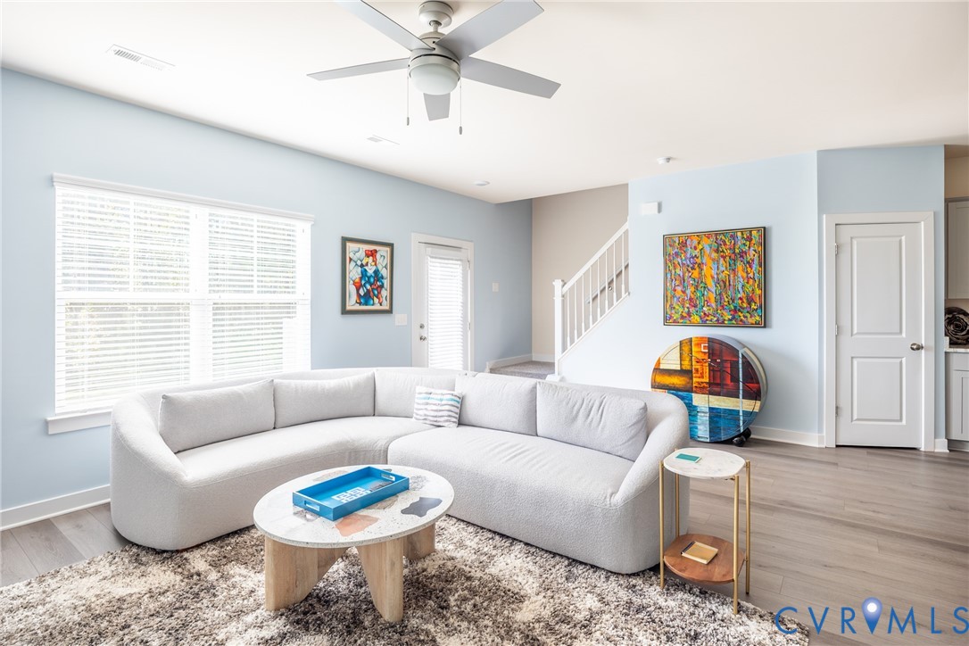 Vaulted ceiling with integrated lighting, wall-to-wall carpeting, and neutral interior paint