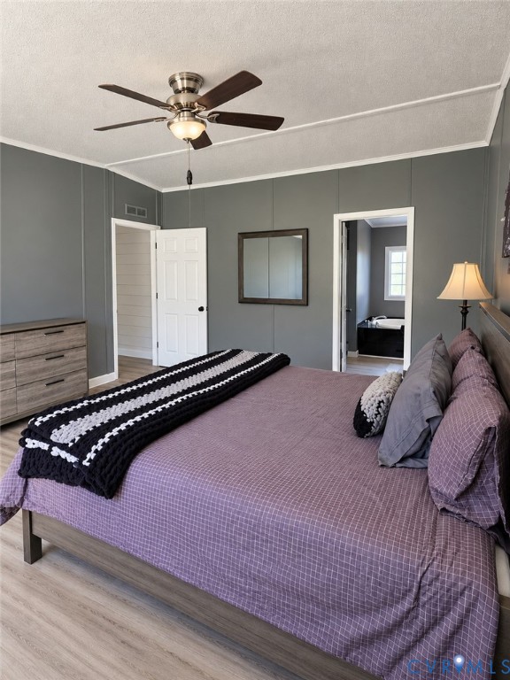 Neutral-toned interior walls, wood-finish flooring, brushed nickel ceiling fan, and white paneled doors