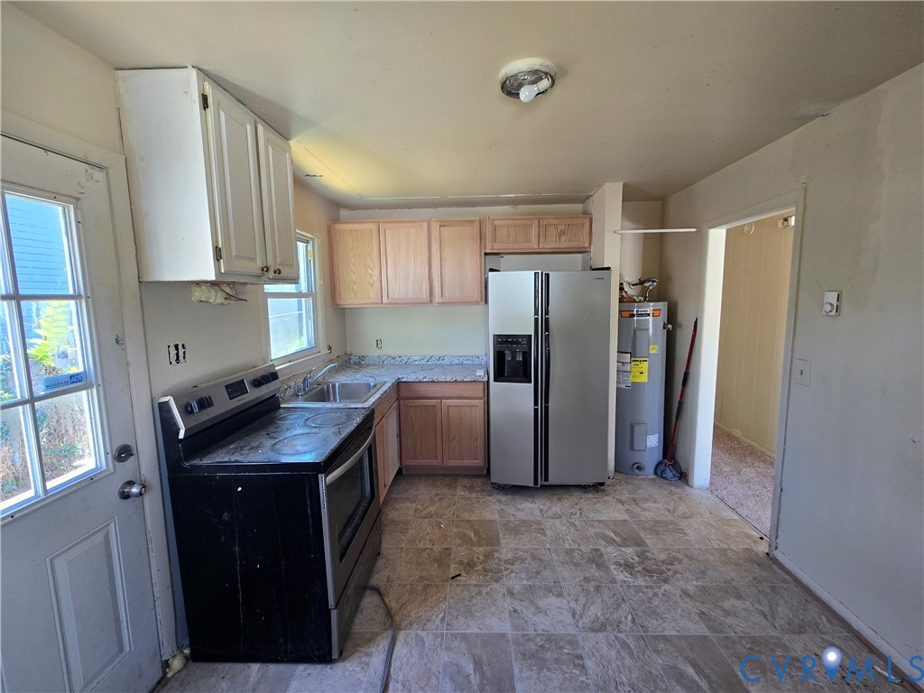 Kitchen featuring wood cabinetry, stone-patterned laminate countertops, stainless steel appliances, and tiled flooring Kitchen featuring wood cabinetry, stone-patterned laminate countertops, stainless steel appliances, and tiled flooring