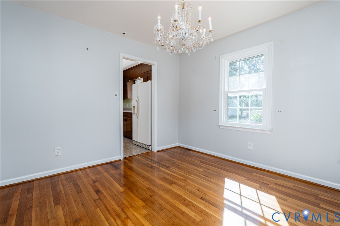 Hardwood flooring, crystal chandelier, and multi-pane window