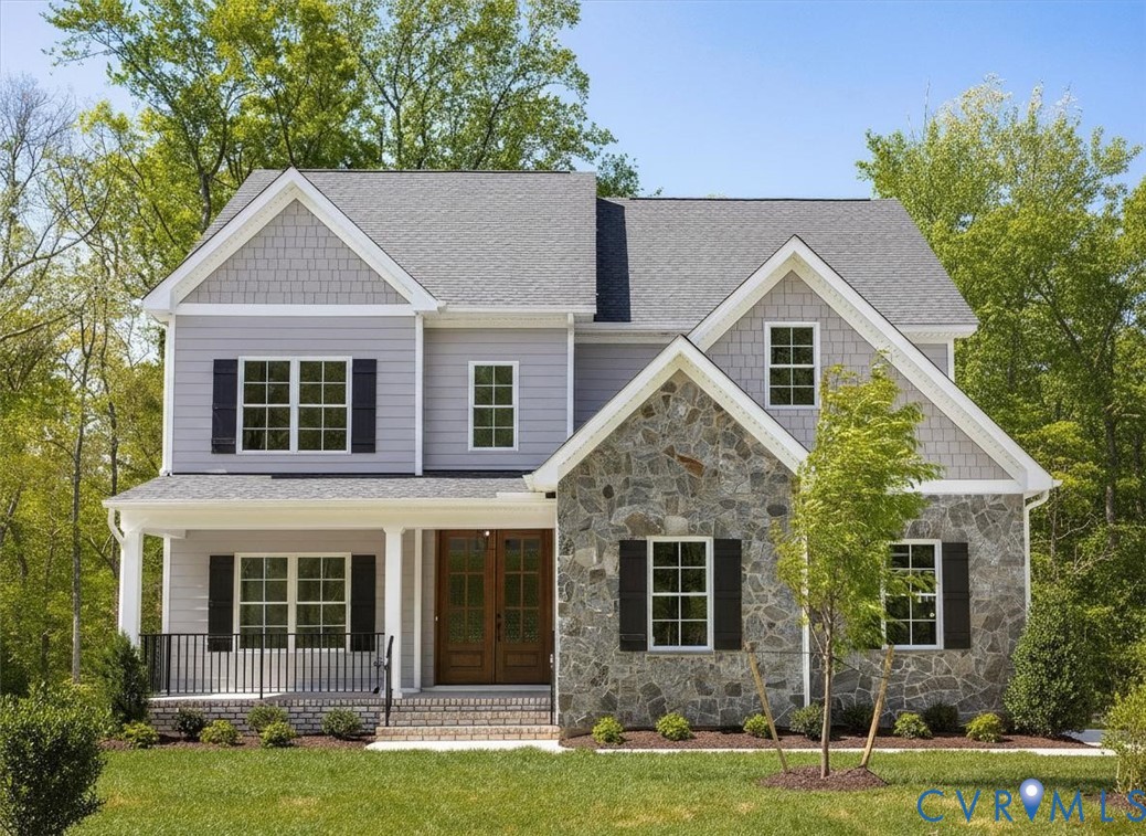 Two-story exterior featuring a mix of stone veneer and horizontal siding, decorative gable accents, covered front porch with metal railing, and double-door entry