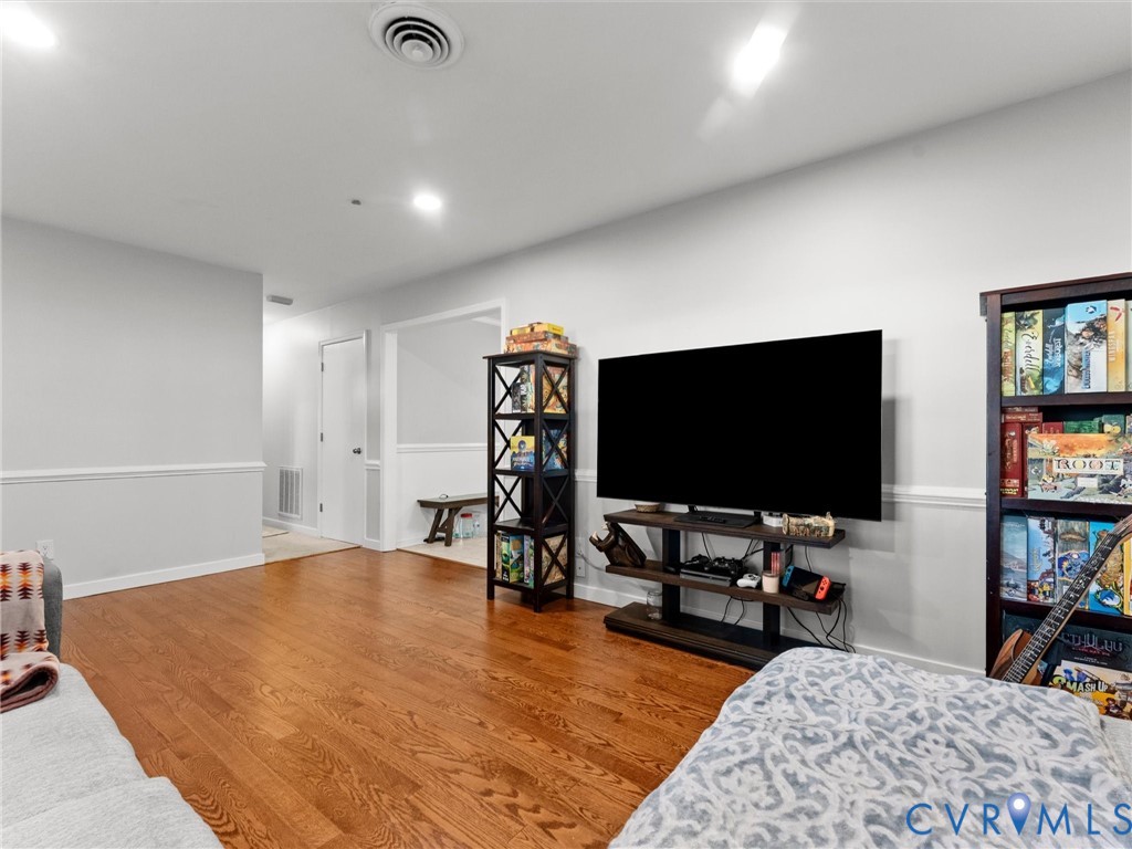 Wood-finish flooring, neutral wall paint, and chair rail molding