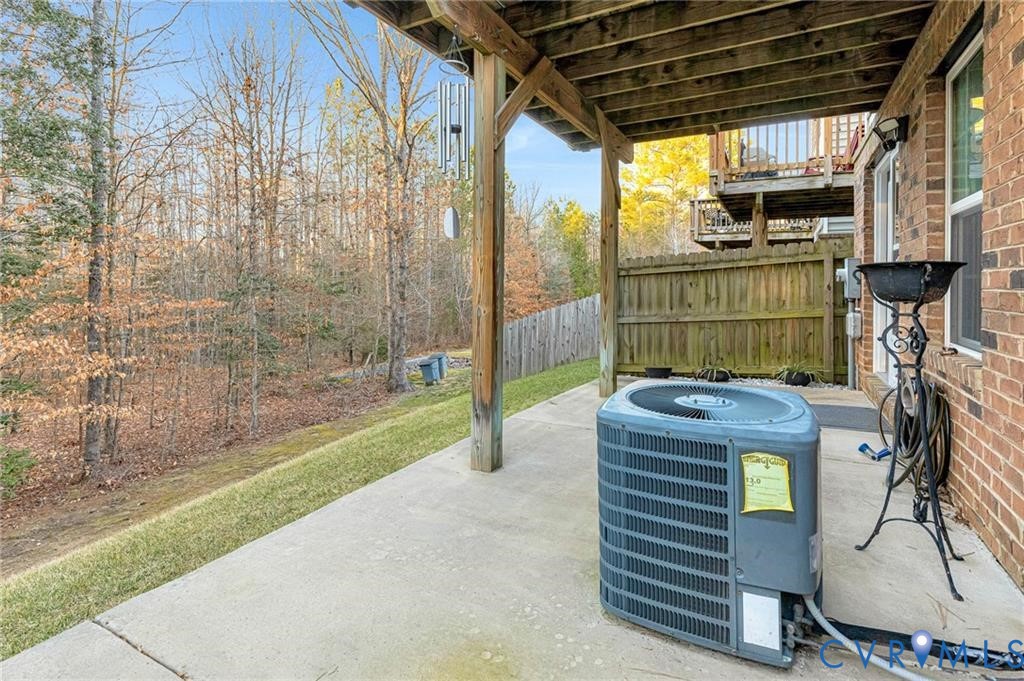 View of patio featuring fence and central AC