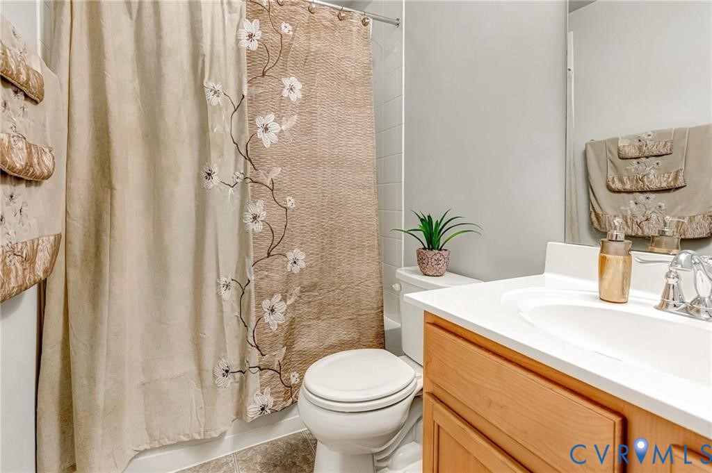 Full bathroom with vanity, toilet, and shower / bath combo