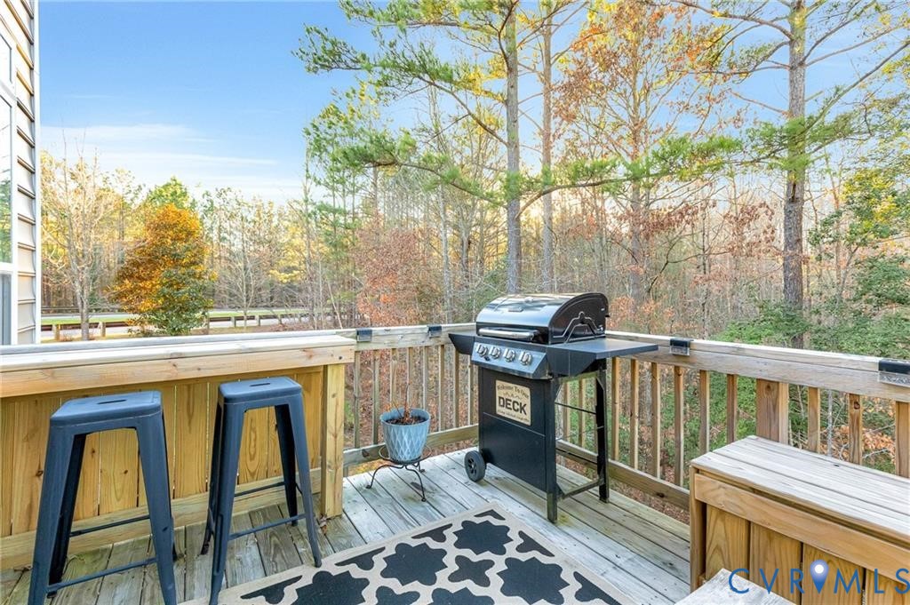 Wooden terrace with outdoor dry bar and a grill
