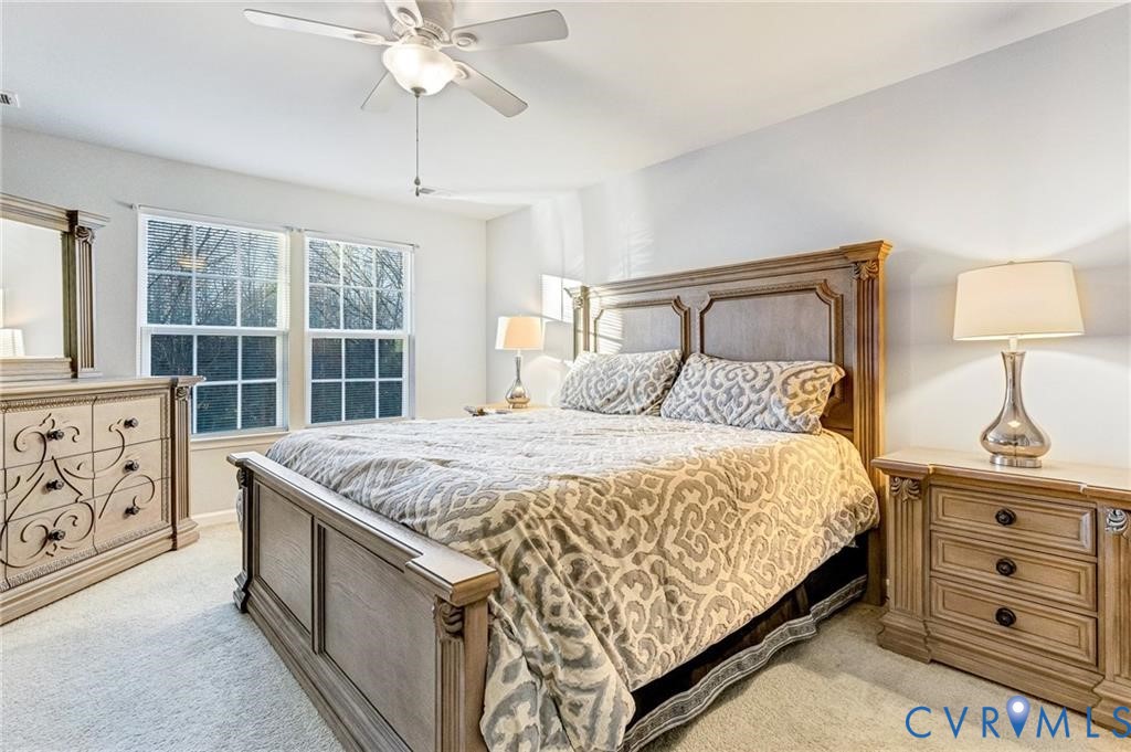 Bedroom featuring light colored carpet and ceiling fan
