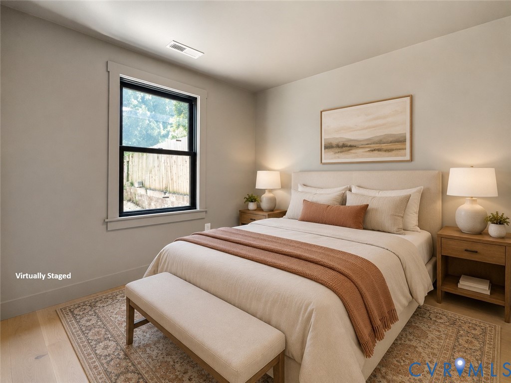 Neutral interior walls, wood-finish flooring, and a single-hung window with a high-contrast dark frame