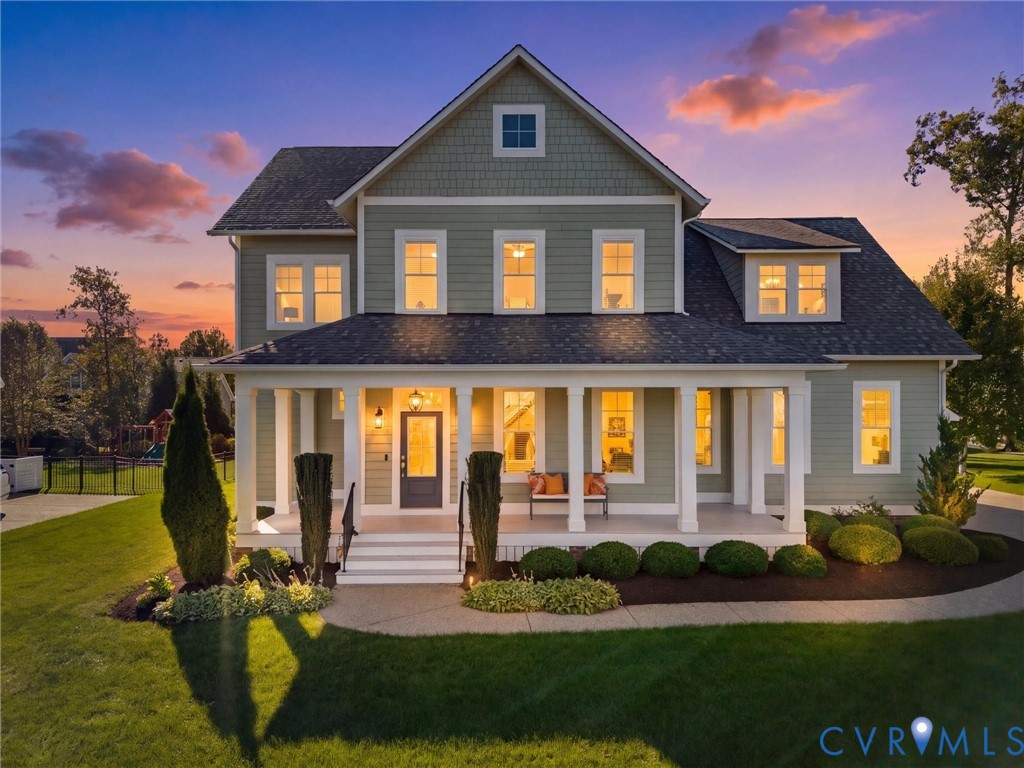 Craftsman-style residence featuring horizontal lap siding, shingle-style gable accents, an expansive full-width covered front porch with square columns, and a landscaped front yard with curated shrubbery Craftsman-style residence featuring horizontal lap siding, shingle-style gable accents, an expansive full-width covered front porch with square columns, and a landscaped front yard with curated shrubbery