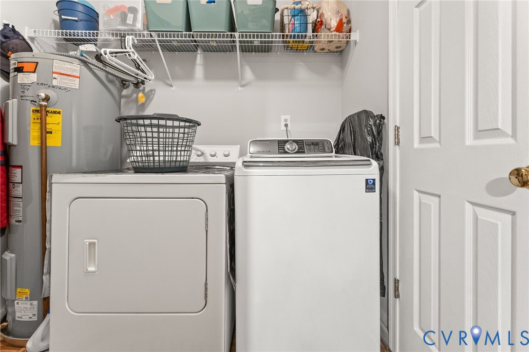 Laundry area featuring a metal wire shelving unit, a water heater, and a multi-panel interior door