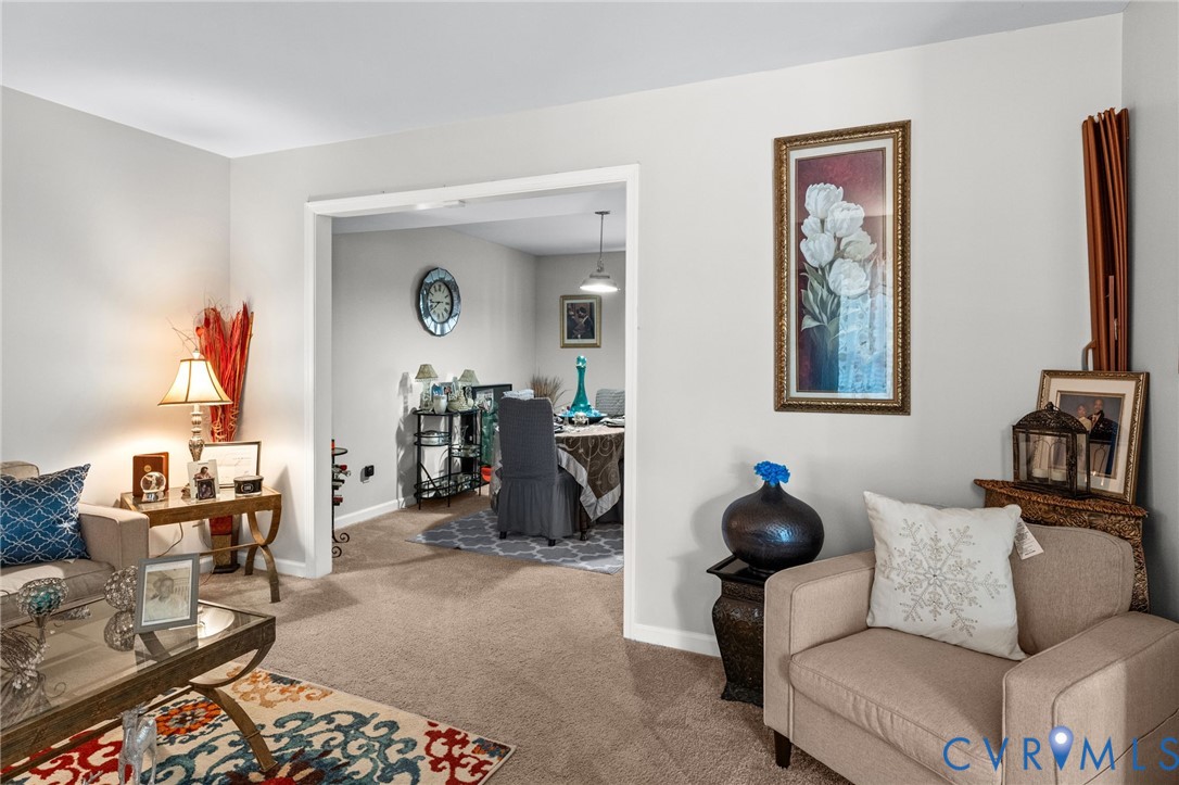 Neutral wall tones, carpeting, and a wide entryway